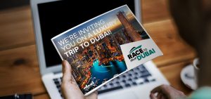 A visual of a man holding a leaflet designed for the Ideal Race to Dubai campaign, by Born + Raised.