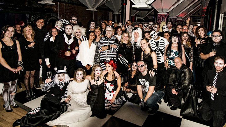 A group photograph taken at the Born + Raised Halloween party in 2015.
