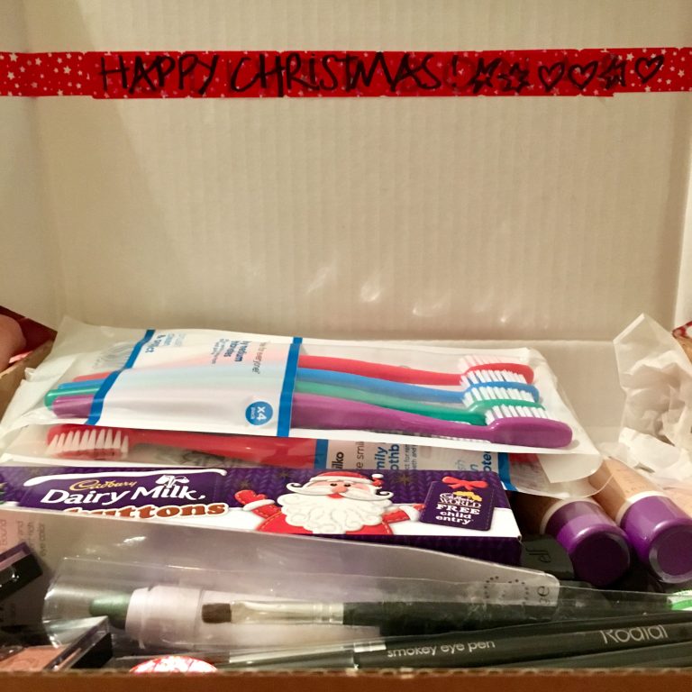 An assortment of toiletry products in a christmas box