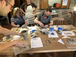 Joanne Ringrose, Finance and Operations Manager and Andrew Loades, Client Relationship Manager, making pottery cups in Chester