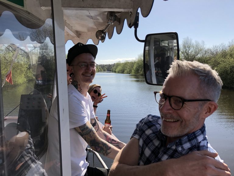 Sam Lightfinch, Copywriter, and Steve Doyle, Head of Copy, celebrating Born and Raised's 8th anniversary on a boat in Chester