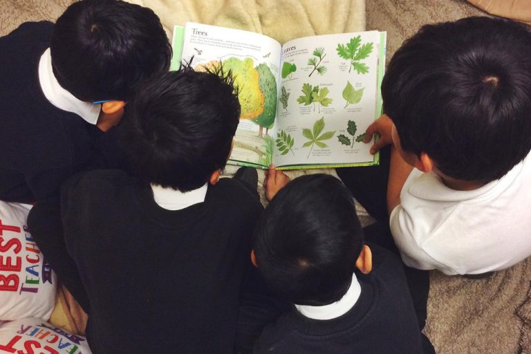 Children from Arboretum Primary School reading a book, Stephen Booth, Senior Account Manager at Born and Raised bought